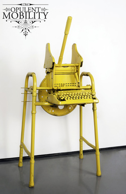 An assemblage of a bright yellow walker, typewriter, and mop wringer with a flag inside