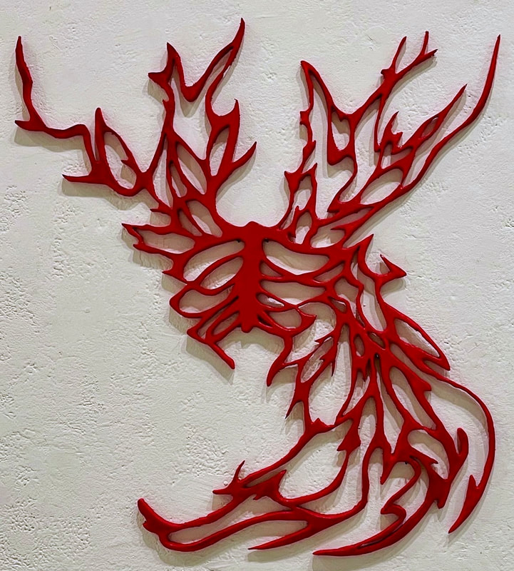 Red cutout Y shaped sculpture with a central ribcage and jagged shapes coming off the shoulders and the lower right side