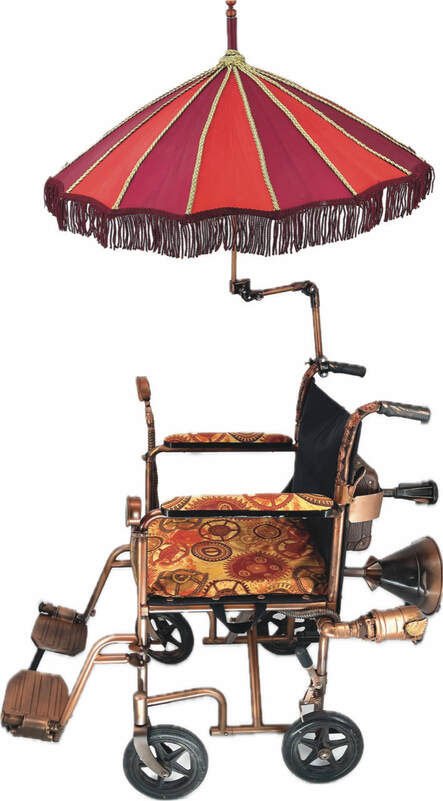 Side view of a wheelchair with added fringed red parasol, gold and red gear cushions on the seat and arms, and extra accessories in back.